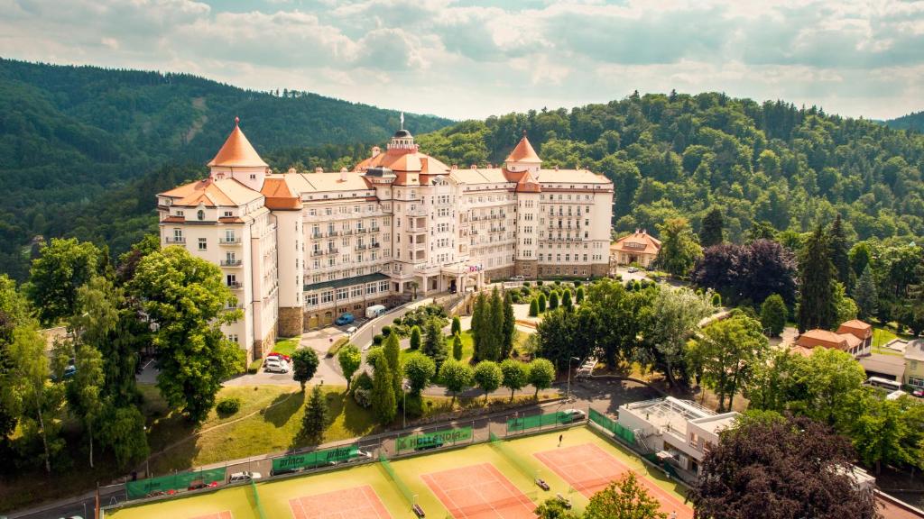 a large building with a clock on the top of it at Spa Hotel Imperial in Karlovy Vary