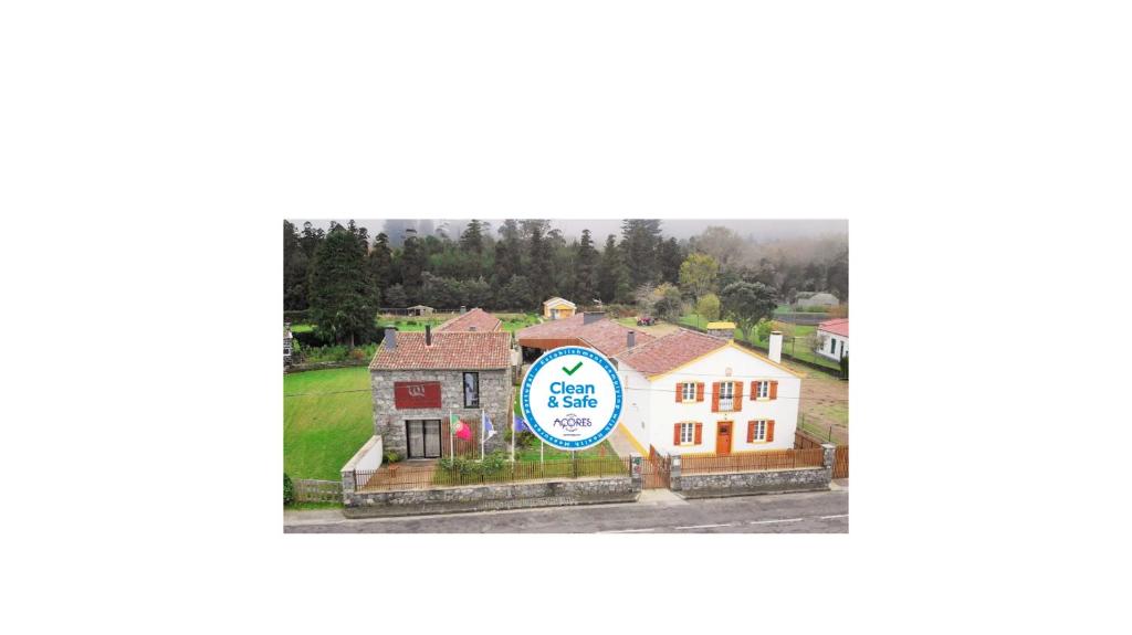 a picture of a house with a sign in front of it at Sete Cidades Quinta Da Queiró in Sete Cidades