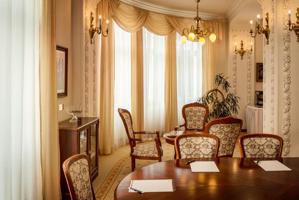 a dining room with a table and chairs at Spa Hotel Imperial in Karlovy Vary