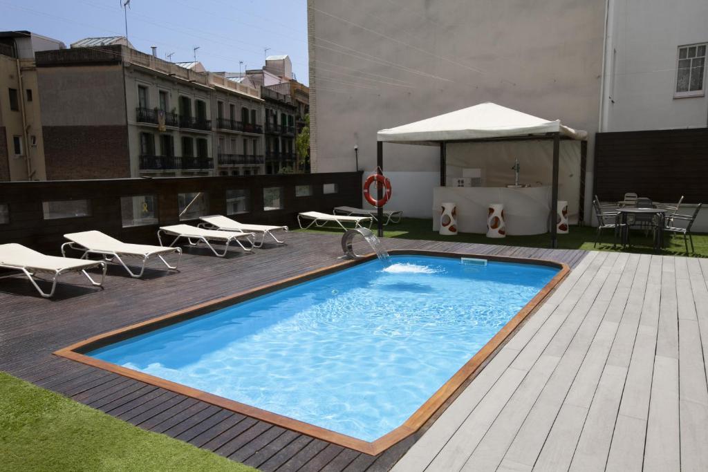 a swimming pool on top of a building at Hotel Concordia Barcelona in Barcelona