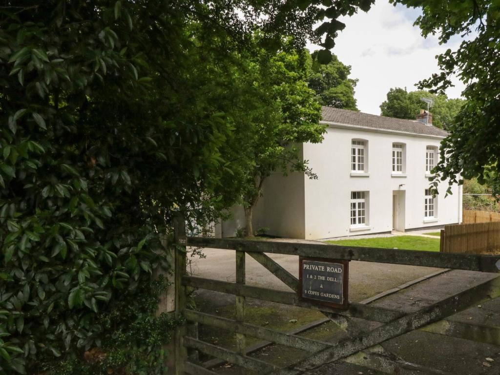 a white house with a sign in front of it at 9 Copes Gardens in Truro