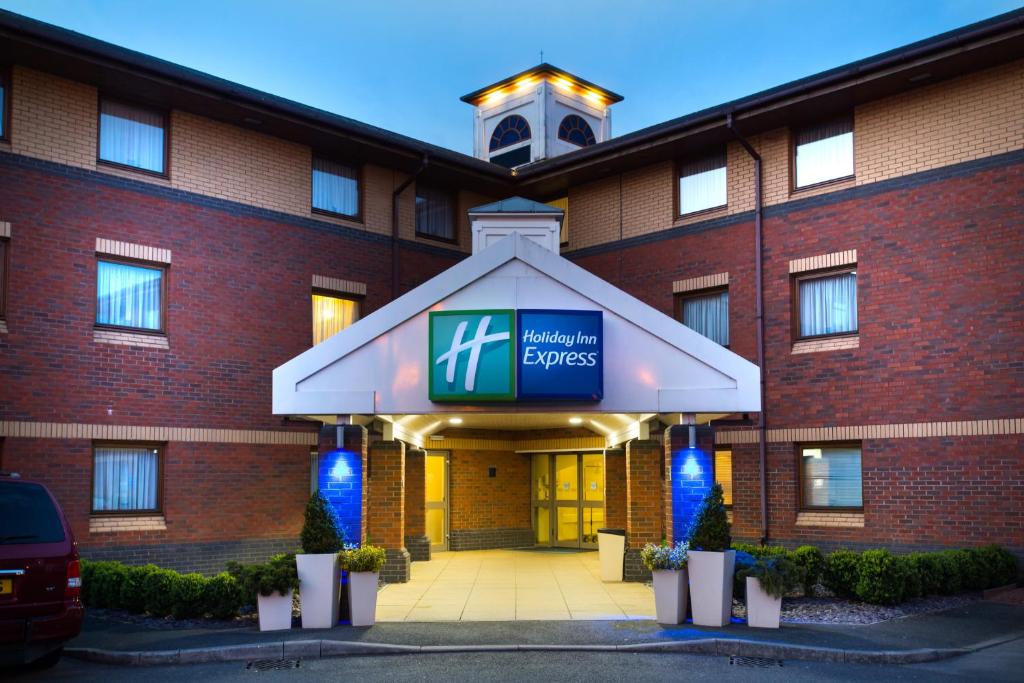 
a large building with a sign on the front of it at Holiday Inn Express Exeter, an IHG Hotel in Exeter
