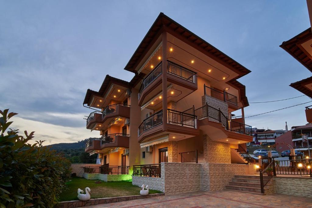 a large apartment building with lights on it at Fotini House in Sarti