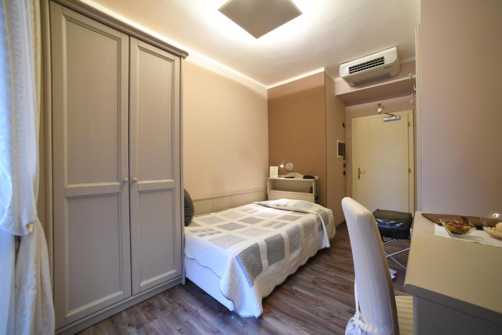 Postel nebo postele na pokoji v ubytování Hotel Lilla'
