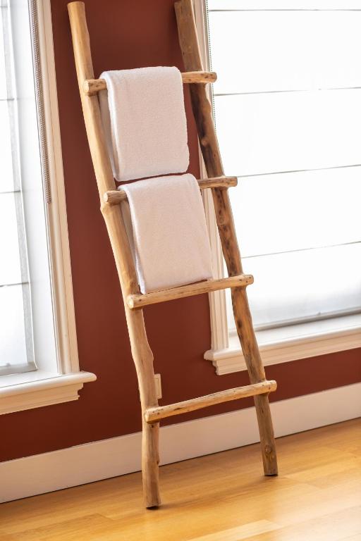 a ladder leaning against a window with a towel on it at Hotel ML in Haarlem