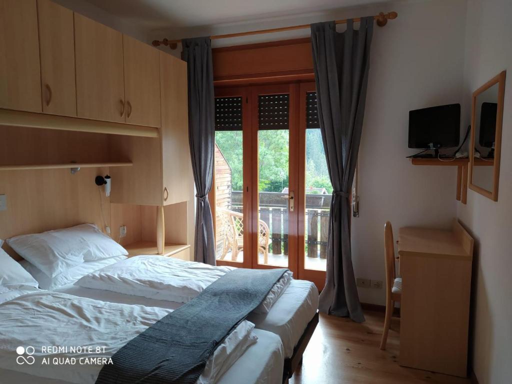 Postel nebo postele na pokoji v ubytování Sporting Hotel Club