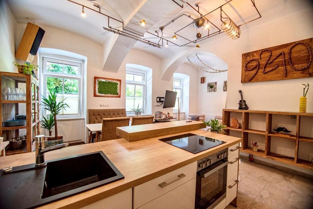 a kitchen with a counter and a living room at Ap9210 in Pörtschach am Wörthersee