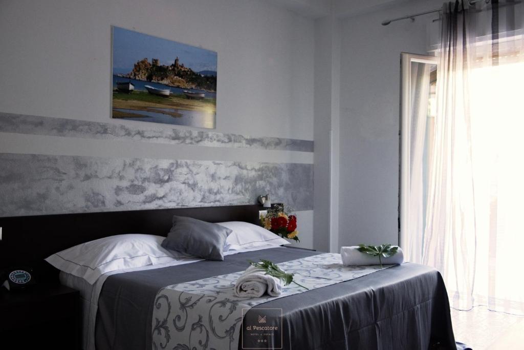 a hotel room with a bed and a window at Al Pescatore in Cefalù