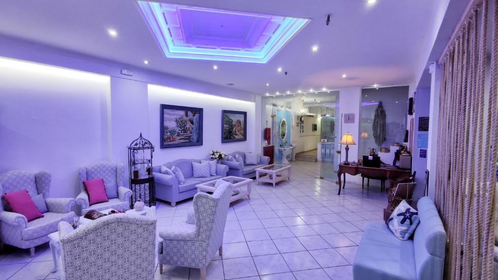 a living room with couches and chairs and a piano at Thalia deco City & Beach Hotel in Hersonissos