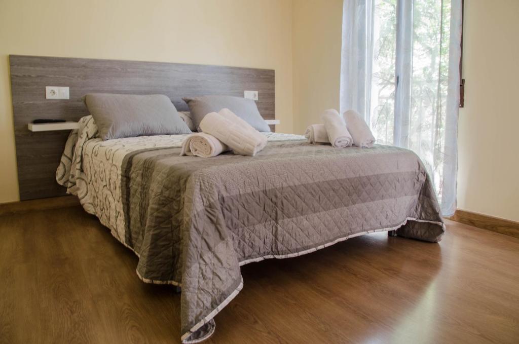 um quarto com uma cama grande com duas almofadas em La Casita de la Plaza em Granada