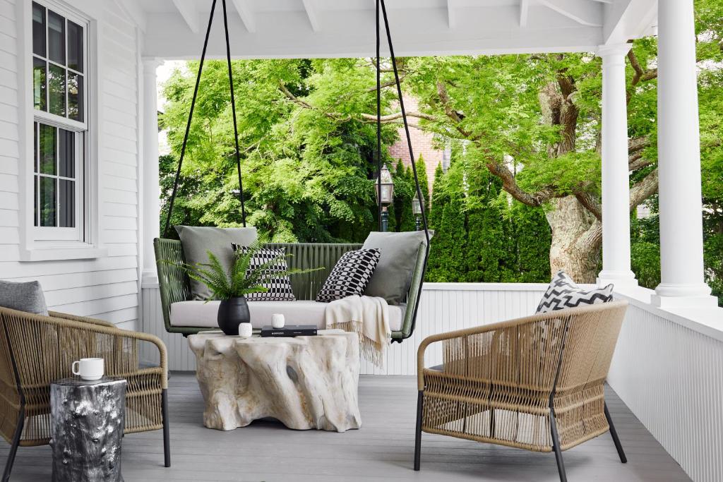 a porch with a couch and chairs and a table at The Edgartown Inn, The Edgartown Collection in Edgartown