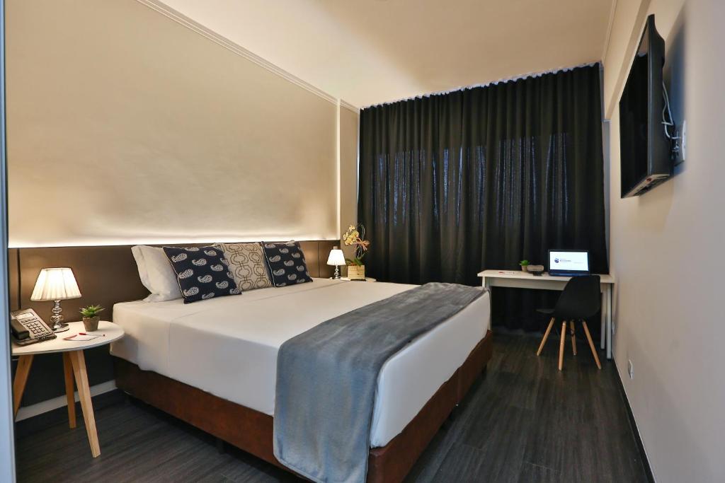 En eller flere senge i et værelse på Transamerica Executive Fernandópolis