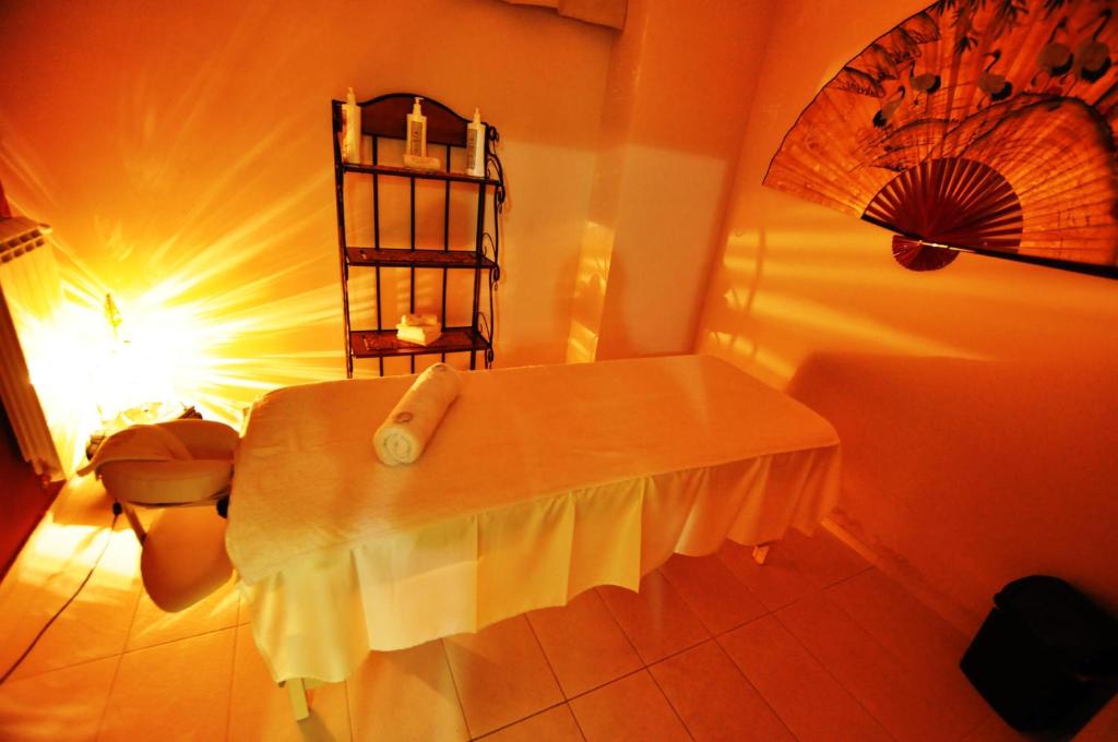 a bathroom with a table and a toilet in a room at Hotel Royal Spa in Banja Koviljača