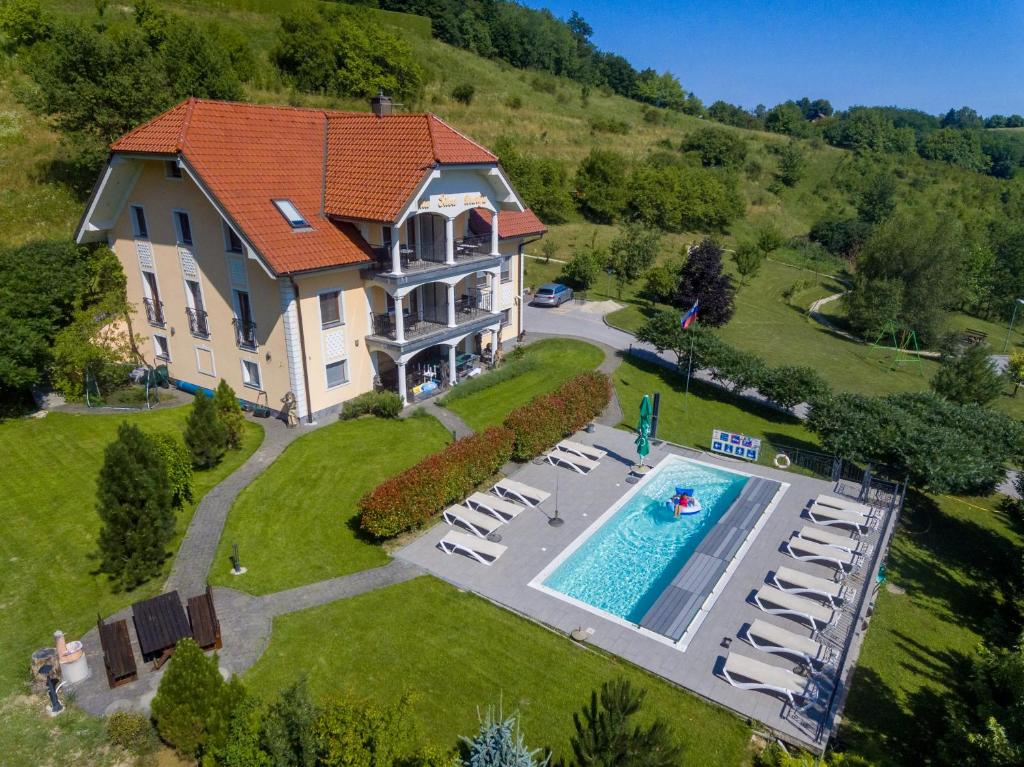 an aerial view of a large house with a swimming pool at Vila Silva Marija Apartments in Pišece