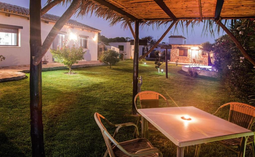 a table and chairs in a yard at night at La Vega del Prado in Tarifa