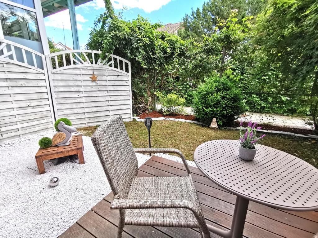 a patio with a table and chairs on a deck at Lillys Apartment Kempten in Kempten
