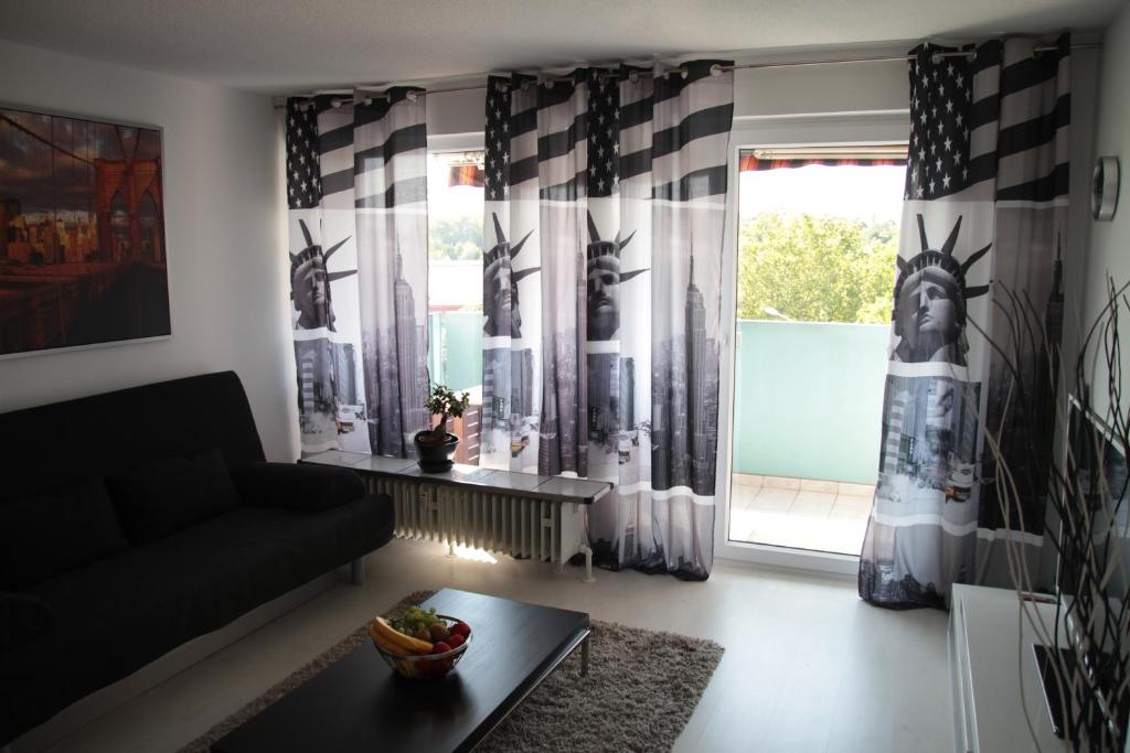 a living room with a couch and a window at 1-Zimmer Business Appartement in Worms