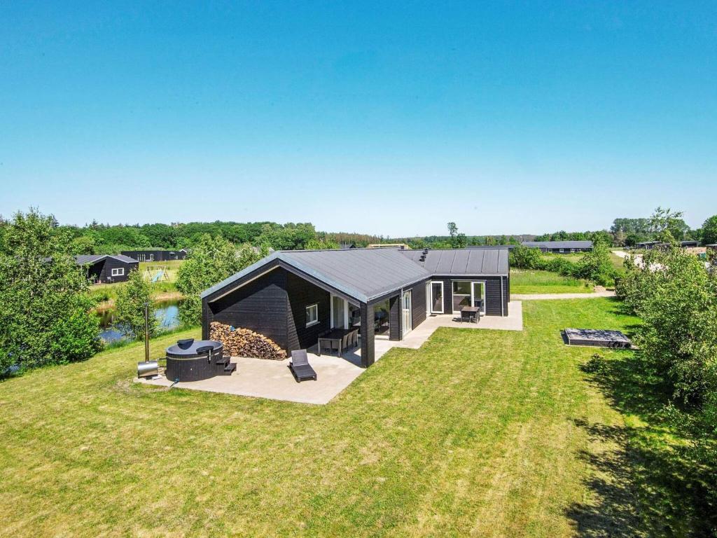 an aerial view of a black house in a yard at 8 person holiday home in Glesborg in Glesborg