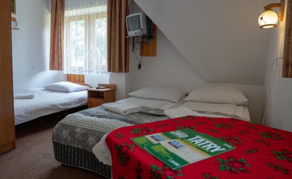 Posteľ alebo postele v izbe v ubytovaní PodKasprowym