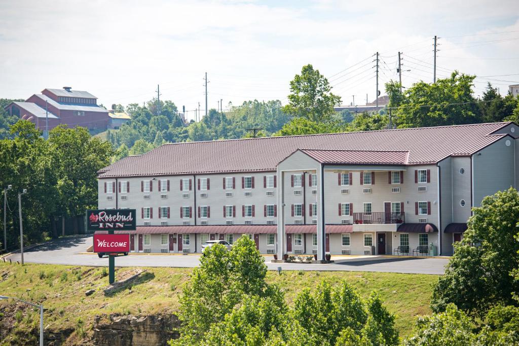 a large white building with a sign in front of it at Rosebud Inn in Branson