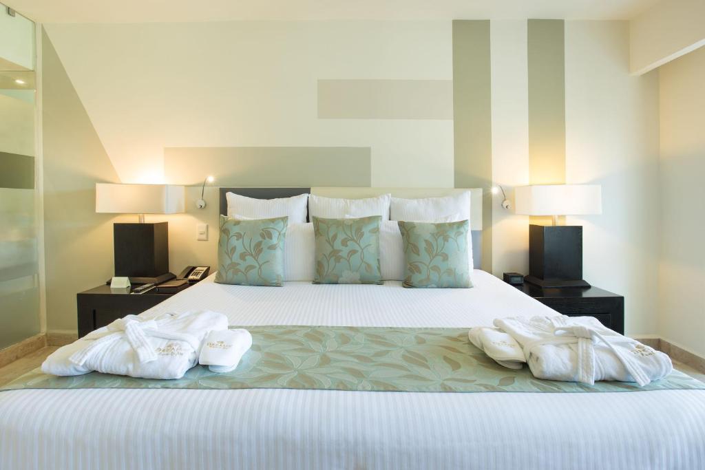Cama o camas de una habitación en Dreams Sands Cancun Resort & Spa