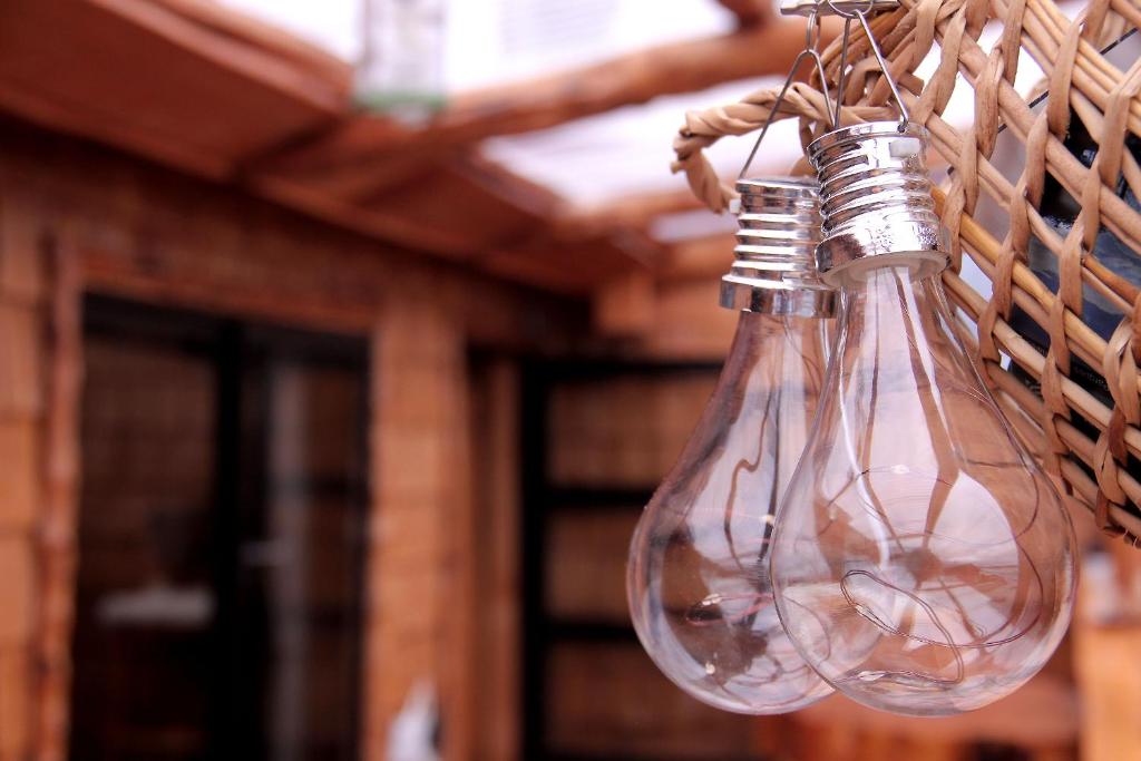 a pair of empty glass bottles hanging from a string at Hotel Mitos in Quellón