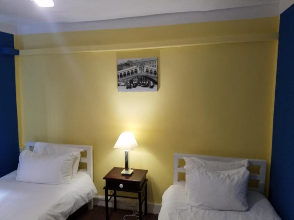 Postel nebo postele na pokoji v ubytování City View Hotel Roman Road