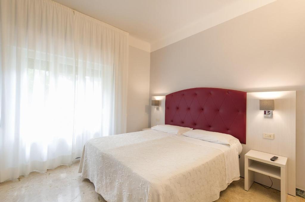 A bed or beds in a room at Albergo Battelli