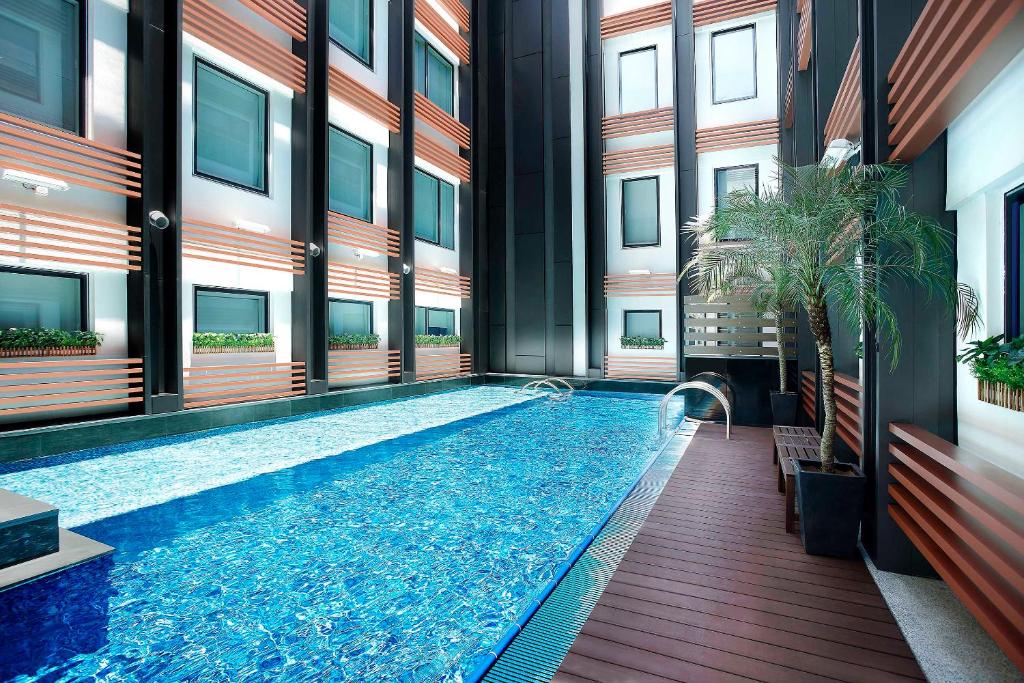 a swimming pool in the middle of a building at Hotel COZi Resort Tuen Mun in Hong Kong