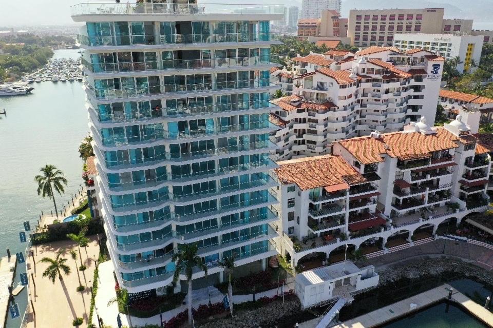 an aerial view of a large building next to the water at Nautico departamento Marina Vallarta in Puerto Vallarta