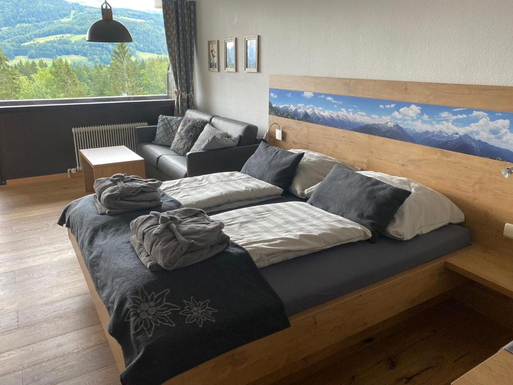 a bedroom with a large bed and a couch at Apartment Sandra in Bad Goisern