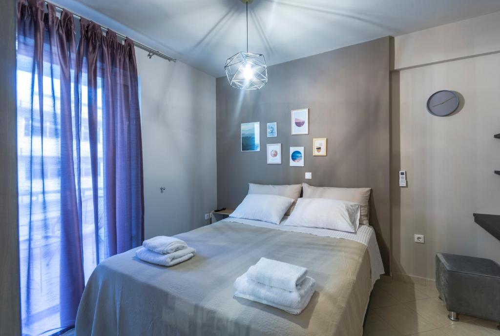 a bedroom with a bed with two towels on it at Nora's Home Kalamata in Kalamata