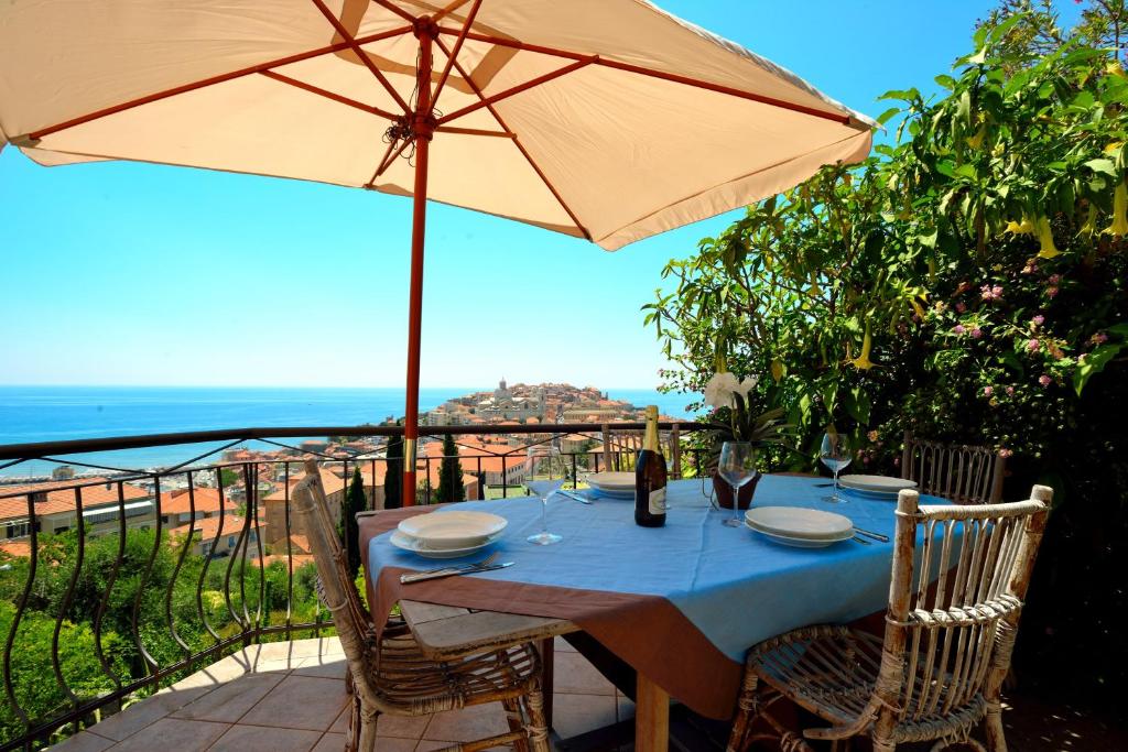 a table with an umbrella on a patio at casa vista mare con wifi, AC nelle 4 camere da letto e parcheggio privato in Imperia