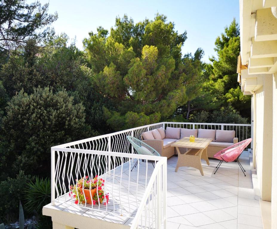 a patio with a couch and a table on a balcony at Apartments Maria in Cavtat