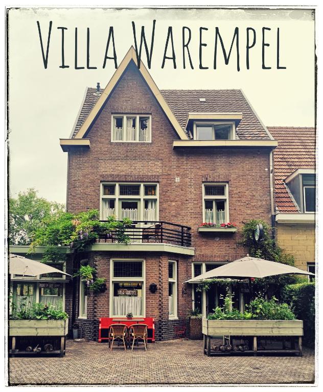 a red brick house with a sign that reads villa warfare at Villa Warempel in Valkenburg