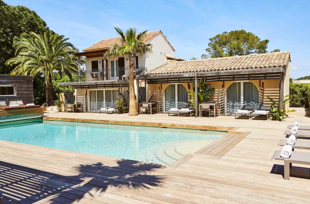 a villa with a swimming pool and a house at Villa Cosy, hotel & spa in Saint-Tropez
