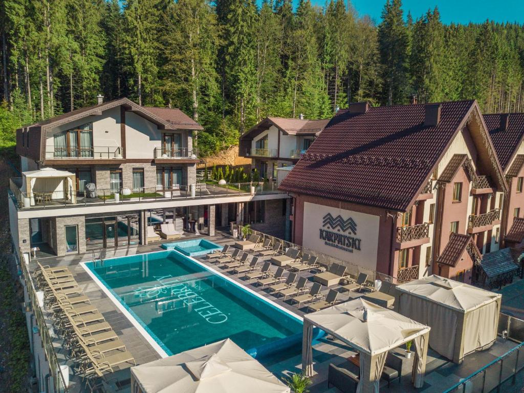 an aerial view of a house with a swimming pool at Karpatski Hotel & Spa in Bukovel