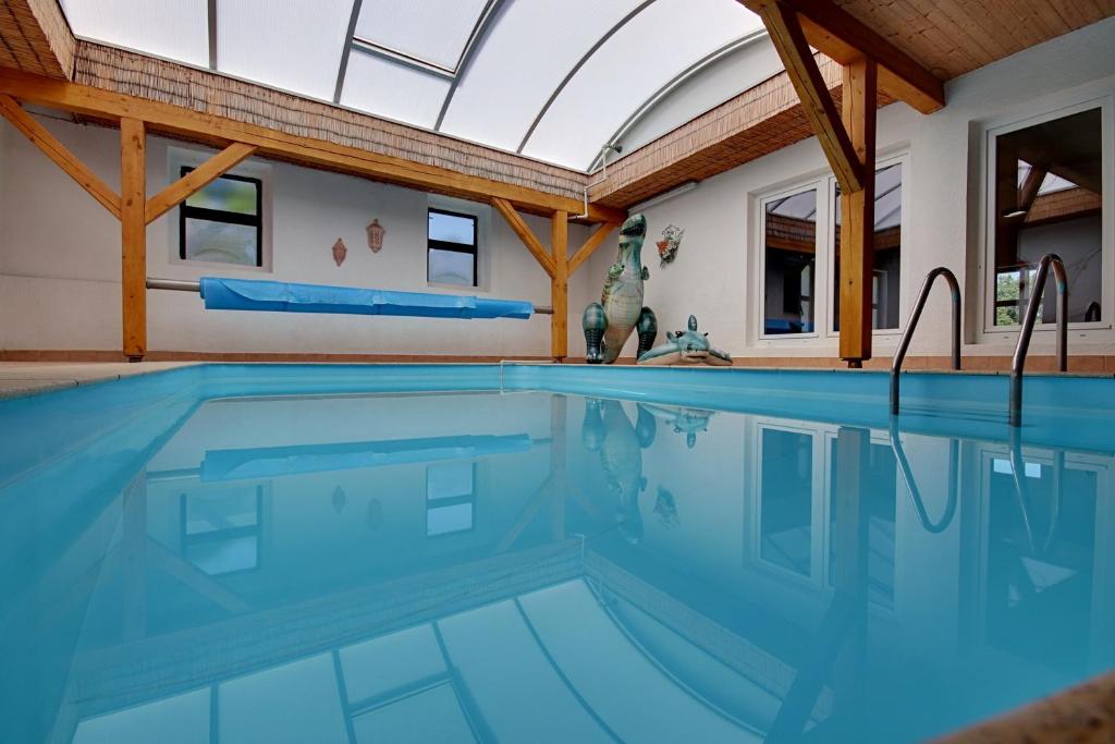 a swimming pool in a house with a skylight at Holiday Home Kvitek in Ctětín
