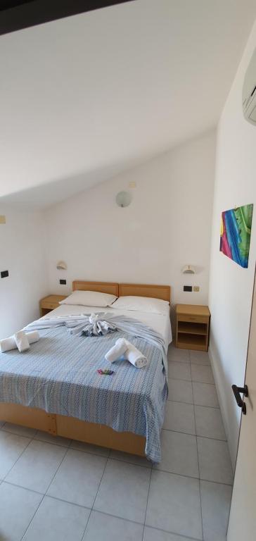 Postel nebo postele na pokoji v ubytování Hotel Vela Azzurra