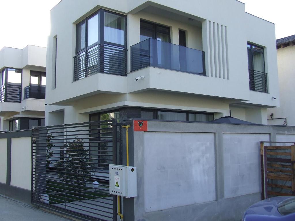 a large white building with a fence in front of it at ALEXYS TOP RESIDENCE in Mamaia Sat/Năvodari