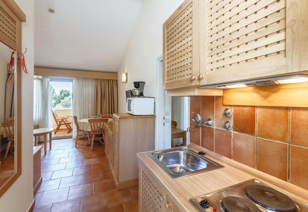 a kitchen with a sink and a counter top at Apartments Bellevue Plava Laguna in Poreč