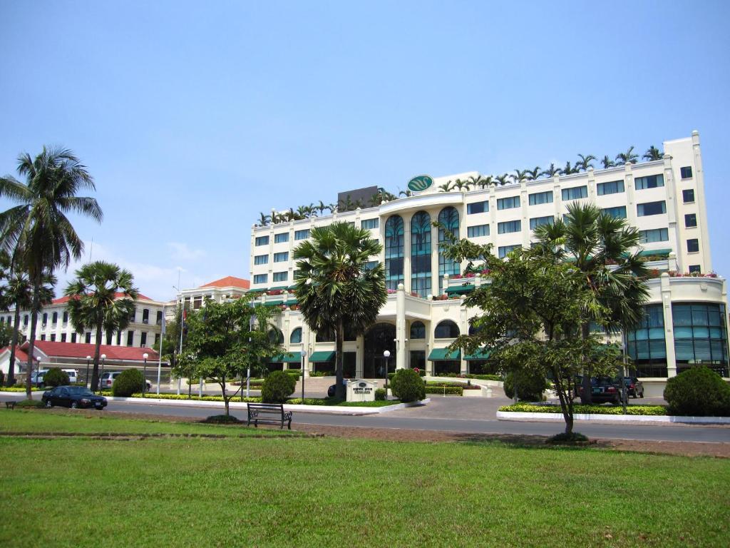 a large white building with birds on top of it at Sunway Hotel Phnom Penh in Phnom Penh