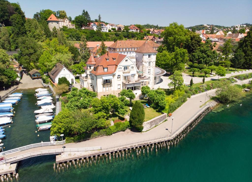 an aerial view of a large house on the water at Bad Hotel Überlingen in Überlingen