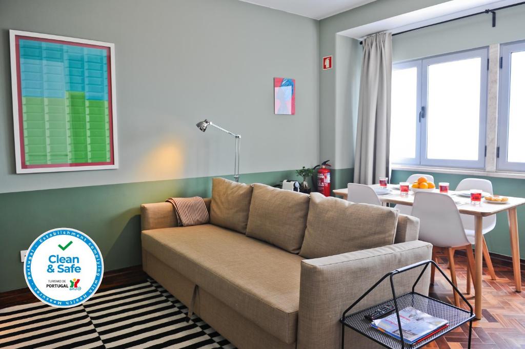 a living room with a couch and a table at White Wine Lovers Apartment 5B in Lisbon