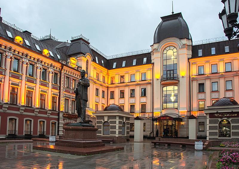 a large building with a statue in front of it at Shalyapin Palace Hotel in Kazan