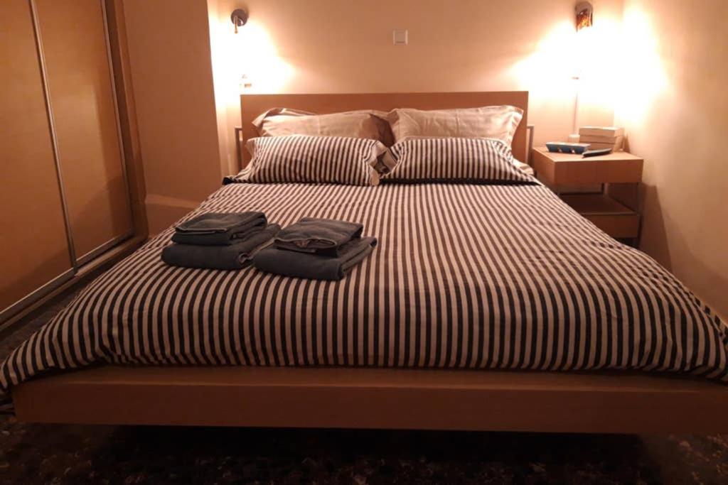 dois sacos de bagagem em cima de uma cama em Luxury Sea-Apartment in the Center of Loutraki em Loutraki