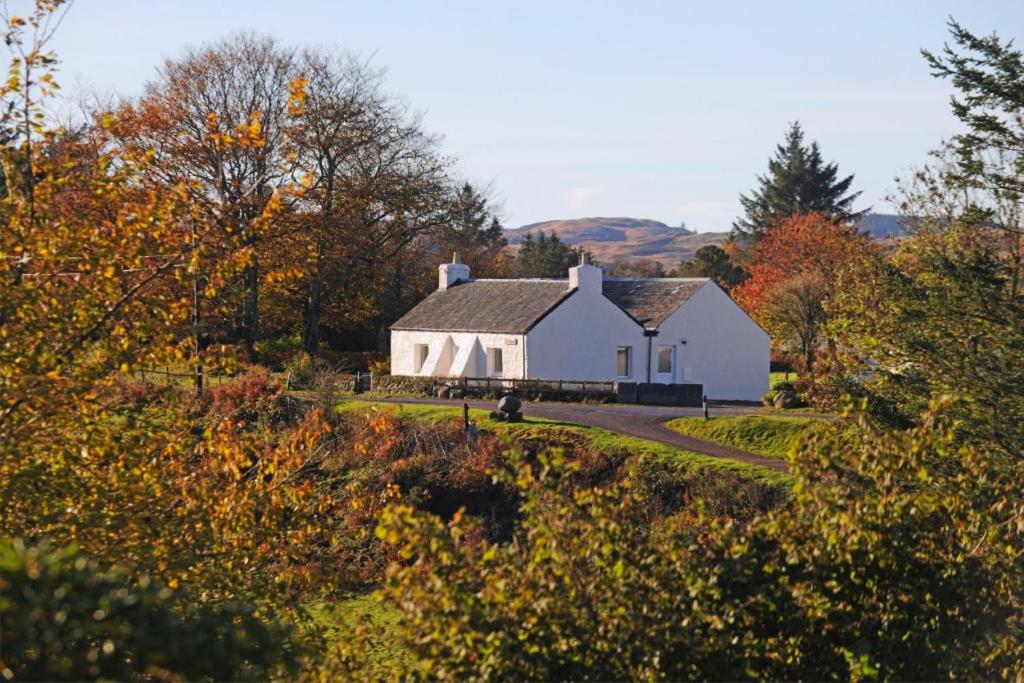 a large white barn with a road leading to it at Tigh Grianach in Connel