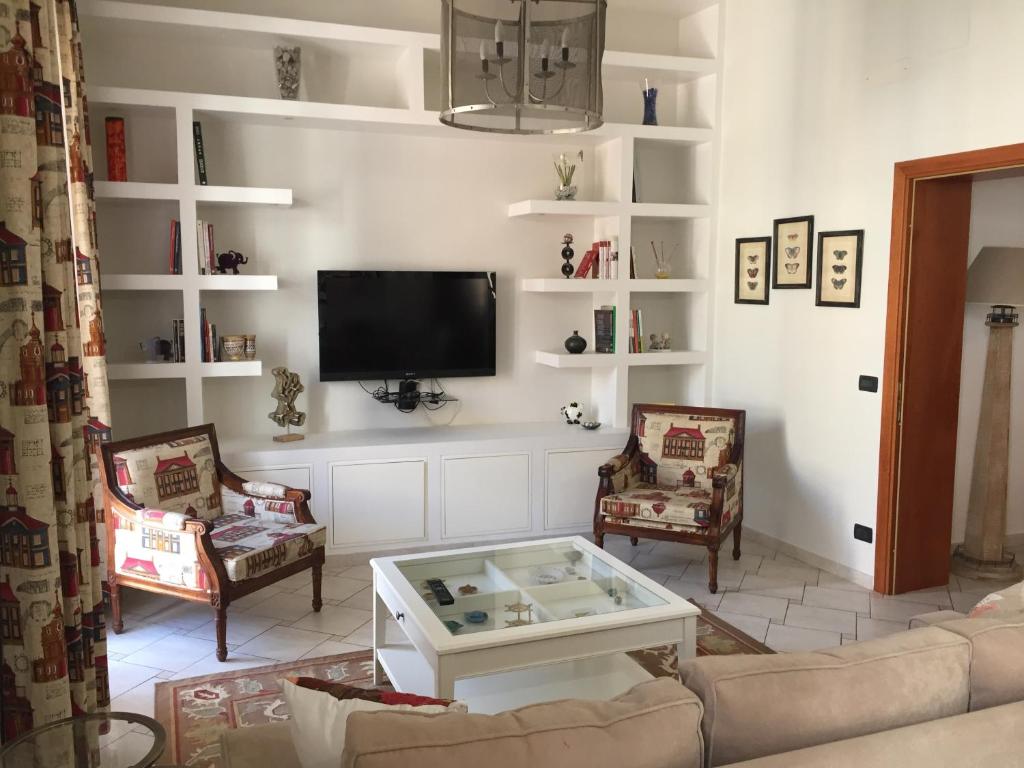een woonkamer met een bank en een tv bij Centro Storico, Piazza Carmine: La Casa di Angela in Reggio di Calabria