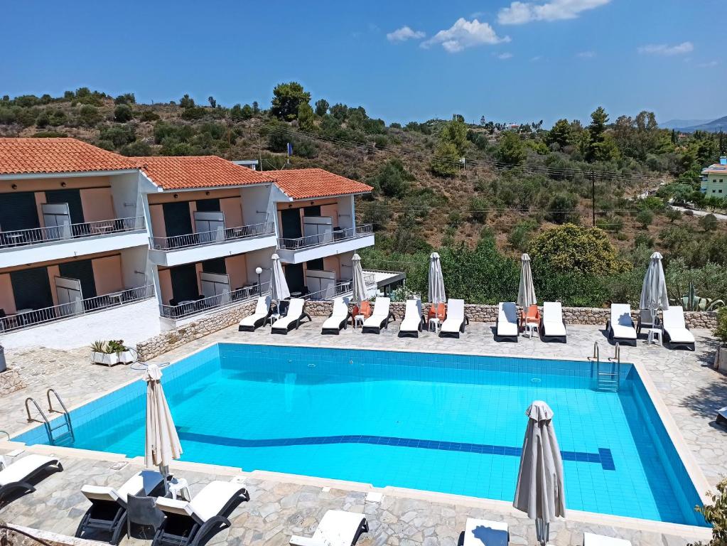 a villa with a swimming pool and a resort at Phaistos Hotel in Tolo