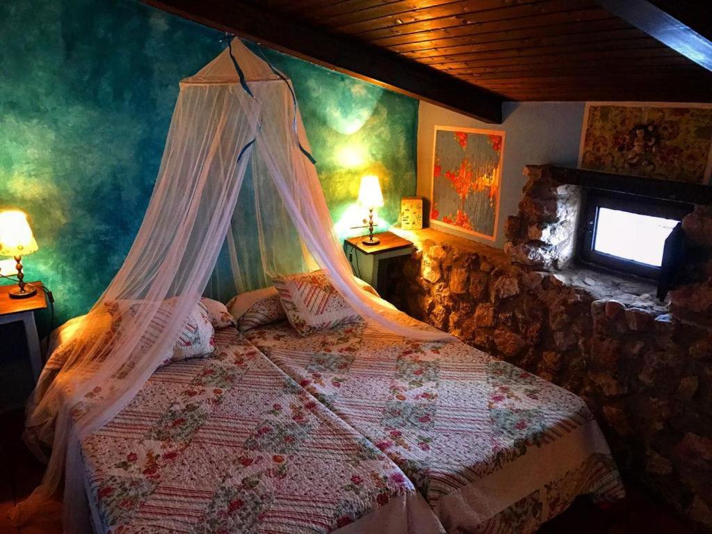 a bedroom with a bed with a mosquito net at Casa rural la Quinta de Malu Romantic hotel in Cuenca Romantic getaways in Valeria